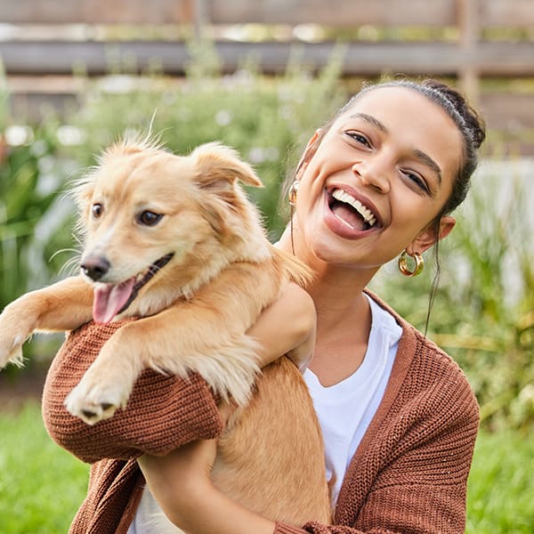 Woman Outside Holding Yellow Dog